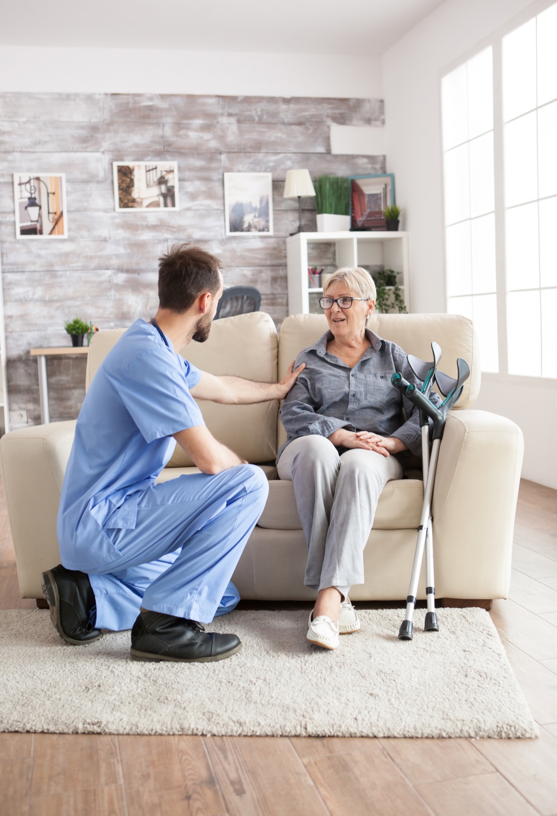 A home health visitor talking with a senior woman at home